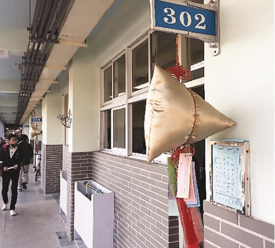 建国中学高三班级门口皆挂有粽子形状的布包，下面写有学生心愿，寓意“包中”。本报记者 冯学知摄