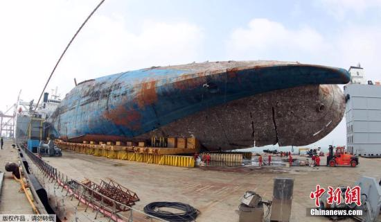 当地时间4月1日，在韩国木浦港，被打捞出水的“世越”号沉船等待被移送上岸。
