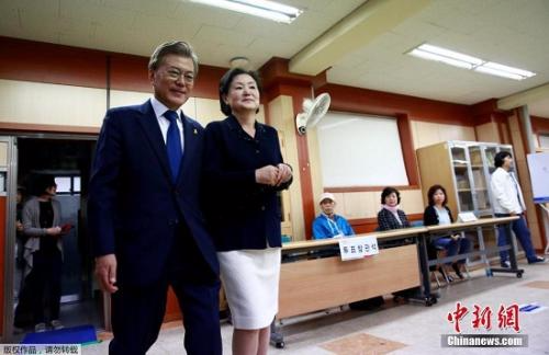 当地时间5月9日，韩国总统大选进入最后投票阶段，支持率领跑的文在寅携妻子前往投票站。