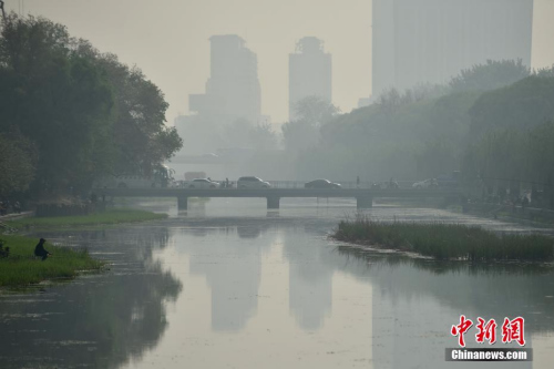 北京迎来沙尘天气市区能见度降低，市民佩戴口罩出行。 <a target='_blank' href='http://www.chinanews.com/' ></table>中新网</a>记者 金硕 摄