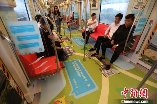 市民乘坐印有南京高校实景手绘图、学姐学长赠言的地铁列车出行。　泱波 摄