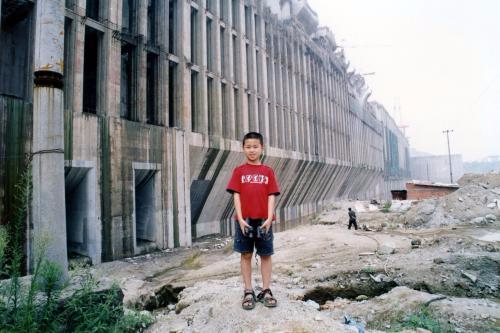 2002年7月，三峡大坝导流明渠截流成功，10岁的儿子在蓄水前的三峡水库留影。 郑之问 摄
